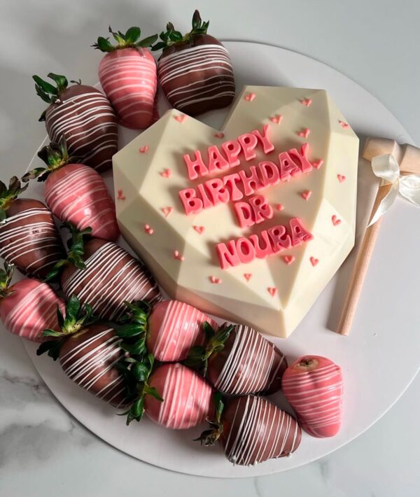 Breakable chocolate heart with dipped strawberries